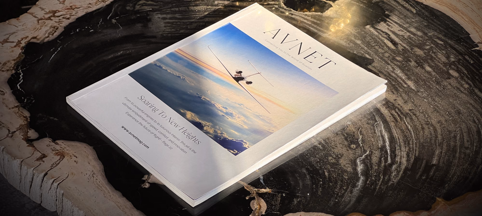 A copy of AVNET magazine resting on a marble table